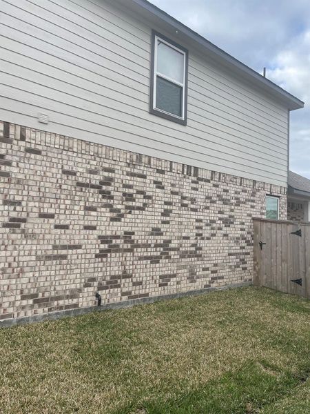 Front exterior of a new home in Huntington Place, Rosharon, TX, highlighting curb appeal (Image 13).