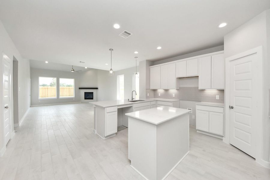 The kitchen is a culinary haven, featuring granite countertops, a tile backsplash, stainless steel appliances, 42” upper cabinets, and undercabinet lighting. The kitchen is a culinary haven, featuring granite countertops, a tile backsplash, stainless steel appliances, 42” upper cabinets, and undercabinet lighting.