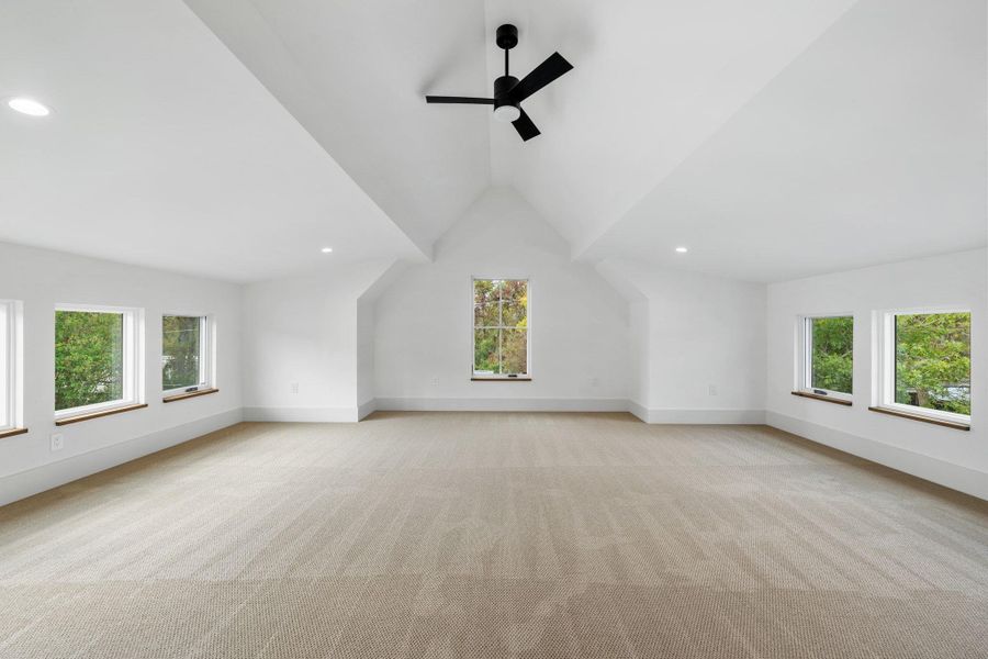 Additional living space featuring recessed lighting, vaulted ceiling, light carpet, and a ceiling fan Additional living space featuring recessed lighting, vaulted ceiling, light carpet, and a ceiling fan