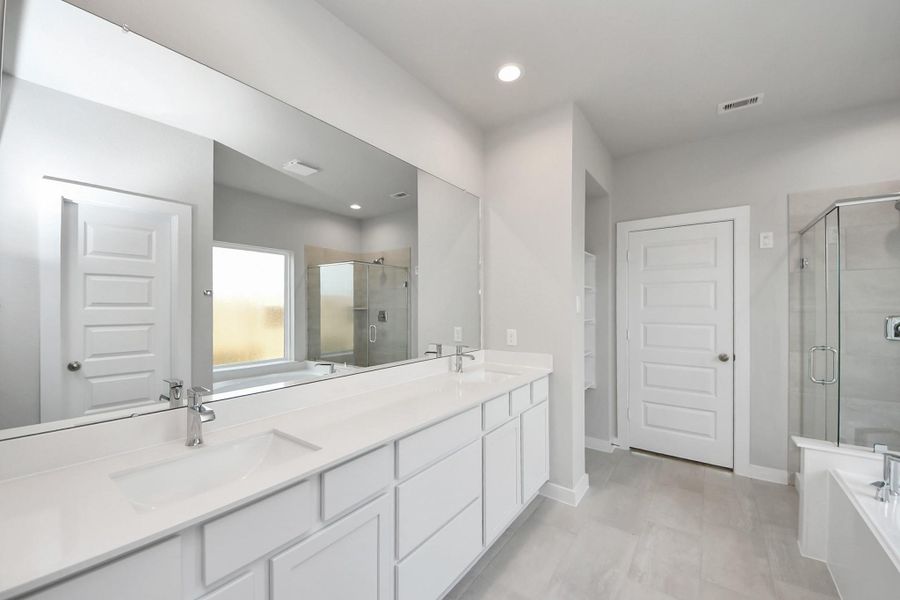Enhance your daily routine at the refined vanity area, which boasts dual sinks, sleek countertops in soft, light tones, and modern fixtures. Enhance your daily routine at the refined vanity area, which boasts dual sinks, sleek countertops in soft, light tones, and modern fixtures.