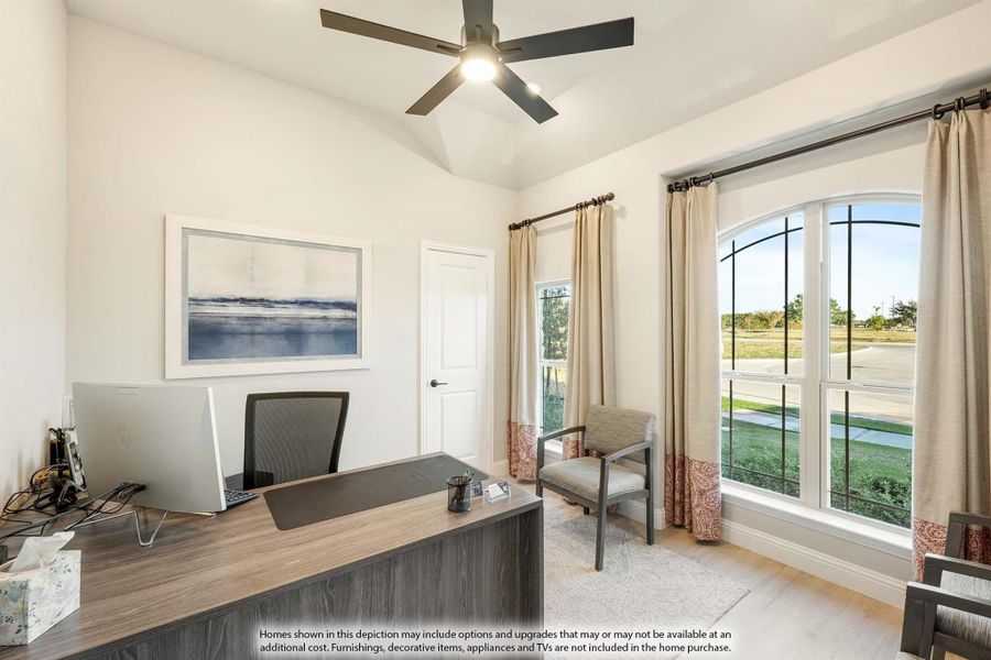 Home office with wood desk, ceiling fan, arched windows, and vaulted ceiling Home office with wood desk, ceiling fan, arched windows, and vaulted ceiling