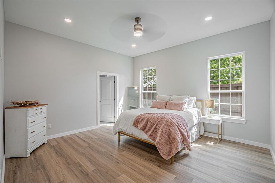 Bedroom with light wood-type flooring, a ceiling fan, and recessed lighting