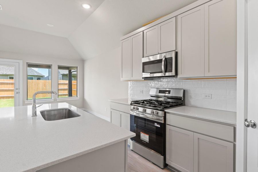 Modern kitchen with sleek counters and stainless appliances, perfect for culinary endeavors.