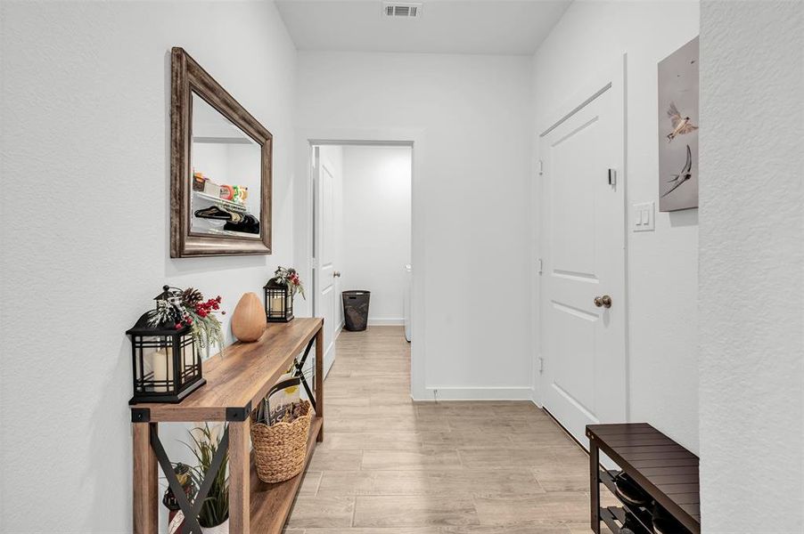 Corridor with light hardwood / wood-style flooring