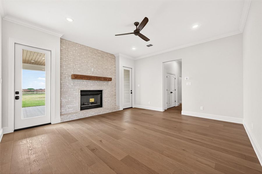 The brick fireplace takes center stage of the living room