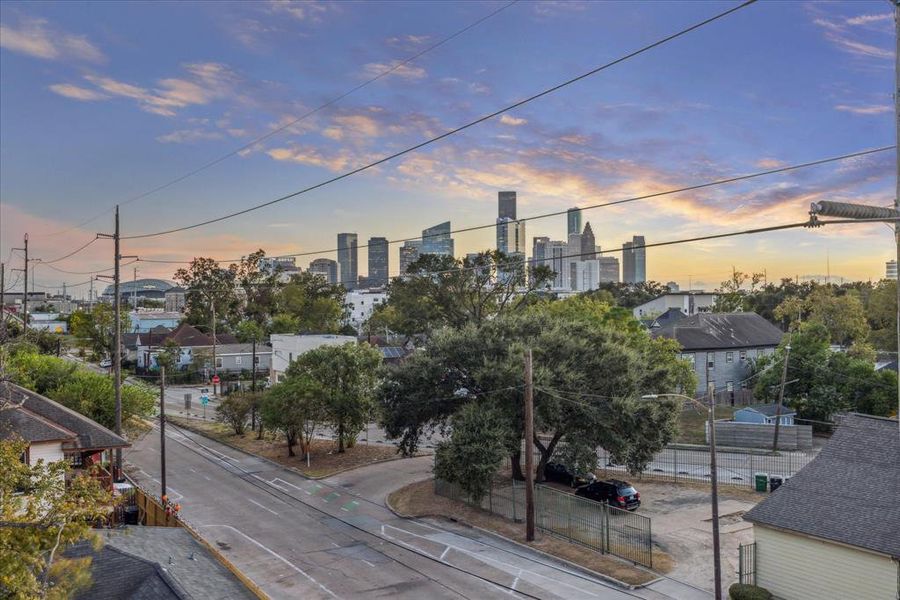 Another captivating view from the rooftop deck showcasing the vibrant downtown skyline. This elevated perspective offers sweeping city vistas, enhancing the urban living experience. Enjoy stunning sunsets and the bustling cityscape from the privacy of your own rooftop retreat.