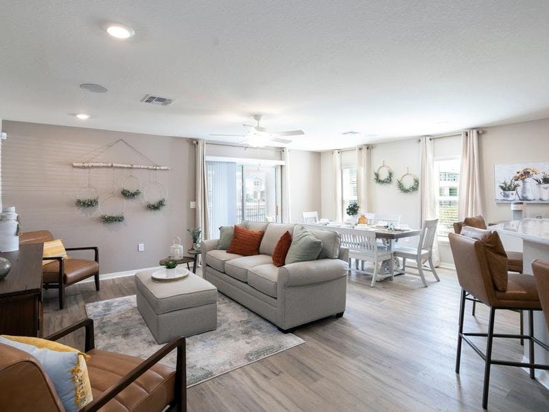 The gathering room is bright and sunny, with ample space for a sectional or your preferred furniture - Magnolia townhome by Highland Homes The gathering room is bright and sunny, with ample space for a sectional or your preferred furniture - Magnolia townhome by Highland Homes