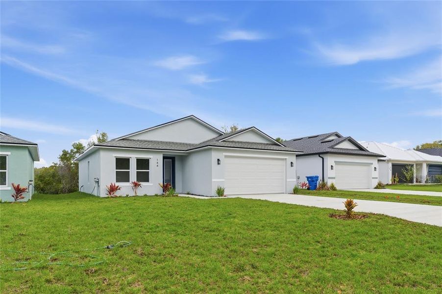 Front exterior of a new home in , Osteen, FL, highlighting curb appeal (Image 19). Front exterior of a new home in , Osteen, FL, highlighting curb appeal (Image 19).