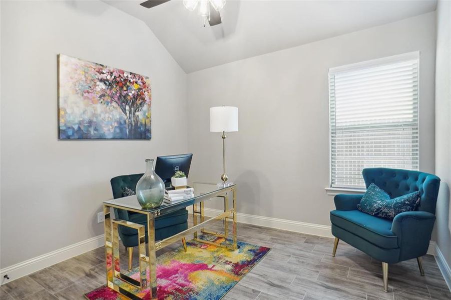 Office space featuring ceiling fan, light hardwood / wood-style flooring, and lofted ceiling