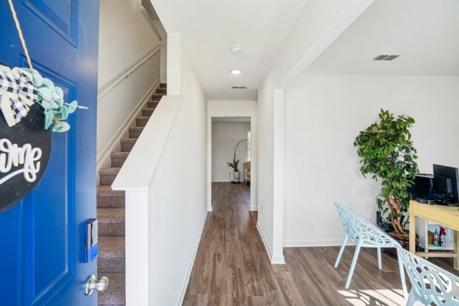 A room with a wood floor and white walls.