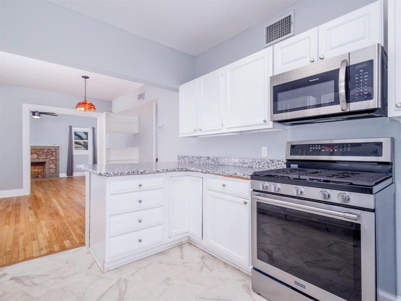 Kitchen offers granite counter tops, gas stove, microwave