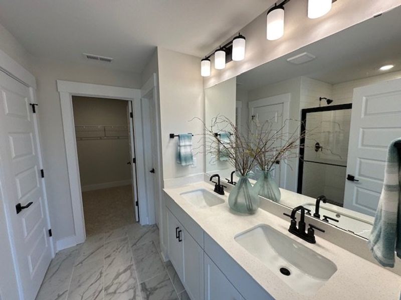 This primary bathroom features a double vanity and