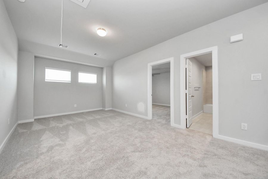 Come upstairs and enjoy a day of leisure in this fabulous game room! This is the perfect hangout spot or adult game room! Features plush carpet, high ceilings, custom paint and windows for plenty of natural light.