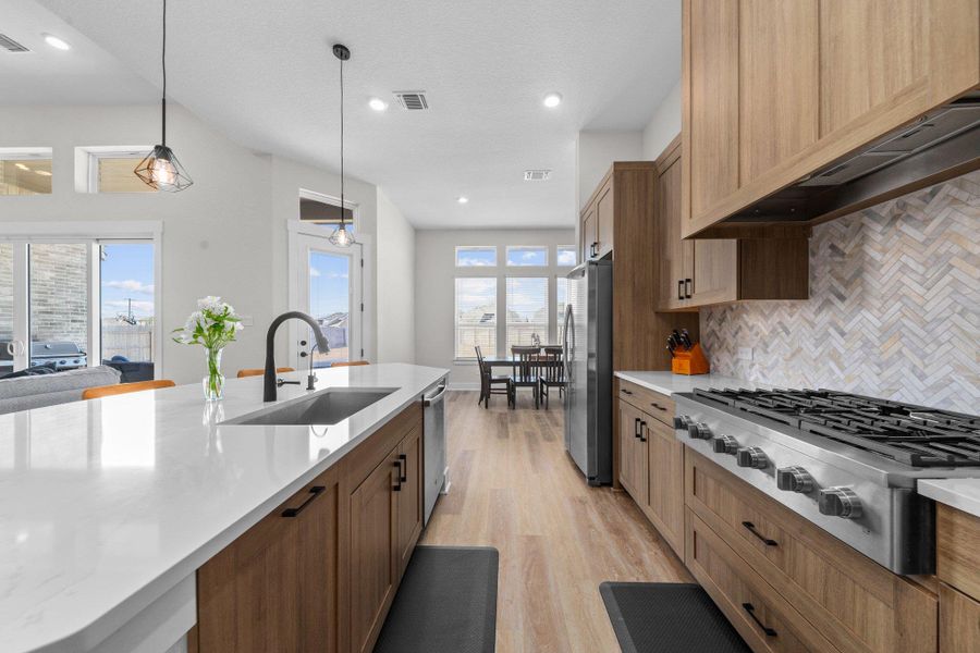 Kitchen with premium range hood, light countertops, appliances with stainless steel finishes