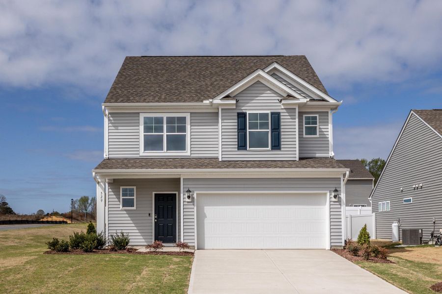 Front exterior of a new home in Daniel Farms, Benson, NC, highlighting curb appeal (Image 1). Front exterior of a new home in Daniel Farms, Benson, NC, highlighting curb appeal (Image 1).