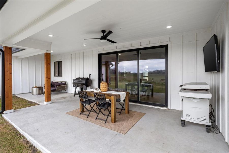 View of patio featuring area for grilling and ceiling fan