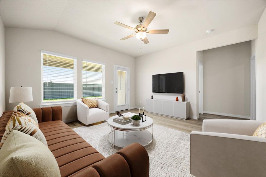 This cozy living area offers abundant natural light, soft neutral tones, and sleek flooring throughout. The open layout provides a comfortable flow to the kitchen and backyard, creating a warm, welcoming atmosphere.