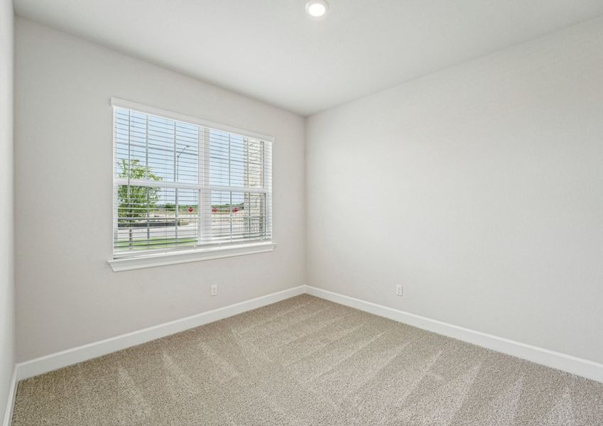 Carpeted secondary bedroom featuring a window with natural light. Carpeted secondary bedroom featuring a window with natural light.