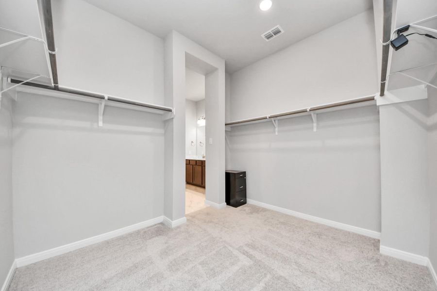 Need closet space? You got it! Primary Closet view facing the primary bathroom!