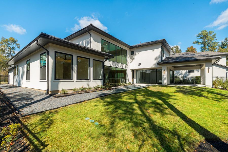 This modern two-story home features a sleek design with large windows and a spacious yard, providing ample natural light and outdoor space. The crisp white exterior and clean lines offer a contemporary aesthetic, ideal for those seeking a stylish and comfortable living environment.
