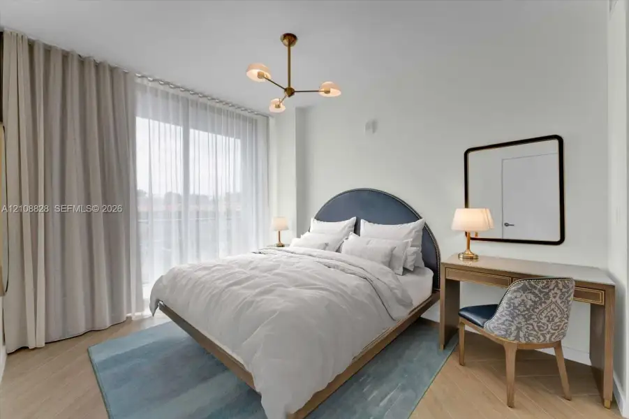 Wood-finish flooring in a herringbone pattern, floor-to-ceiling drapery, and a modern multi-arm chandelier