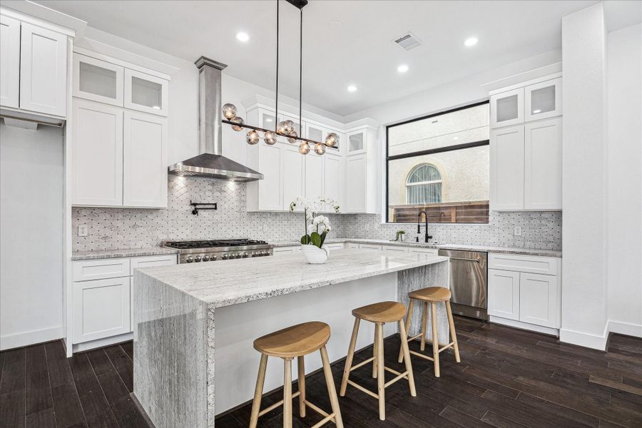 The eat-in island kitchen offers generous seating and a seamless flow, making it ideal for casual dining, entertaining, and everyday living.