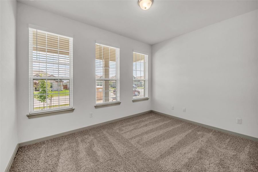 Unfurnished room with light carpet