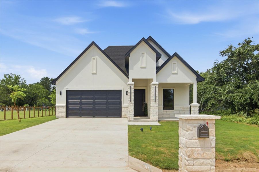 Modern façade with sharp rooflines and mixed-material finishes creates inviting curb appeal. Modern façade with sharp rooflines and mixed-material finishes creates inviting curb appeal.