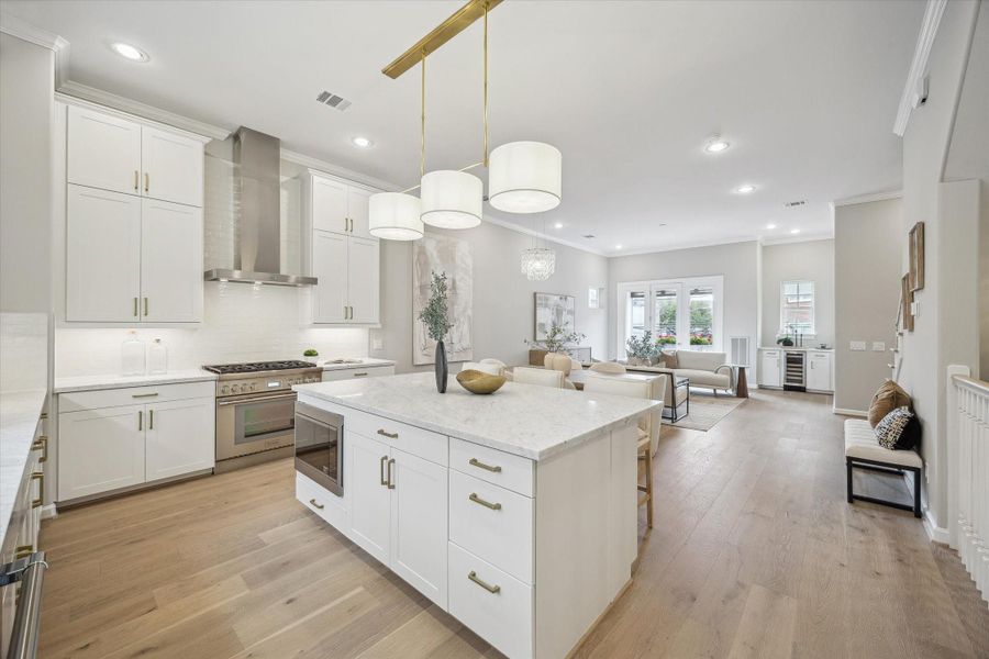 Kitchen featuring a Thermador gas range, stainless steel vent hood, microwave and dishwasher.
