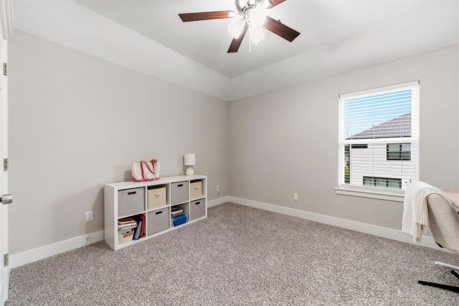 Versatile secondary bedroom easily adapts as a home office, playroom, or creative workspace.
