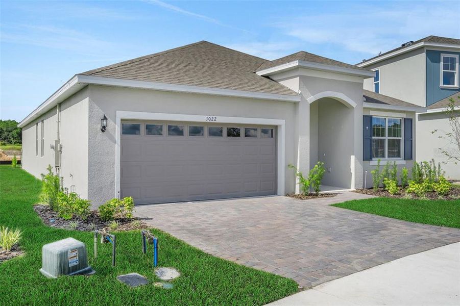 Front exterior of a new home in Reserve at Hammock Oaks, Lady Lake, FL, highlighting curb appeal (Image 1). Front exterior of a new home in Reserve at Hammock Oaks, Lady Lake, FL, highlighting curb appeal (Image 1).