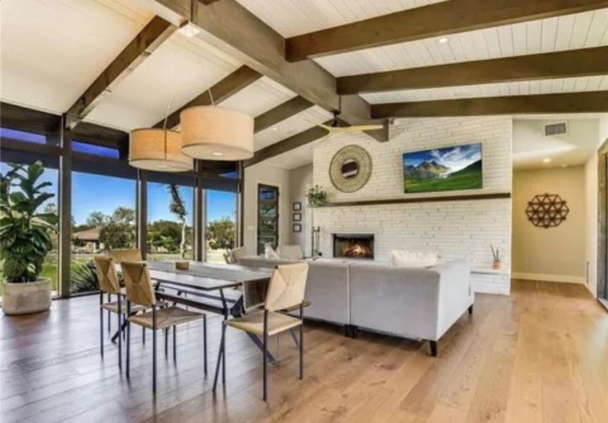 Dining area featuring hardwood / wood-style floors and a fireplace Dining area featuring hardwood / wood-style floors and a fireplace