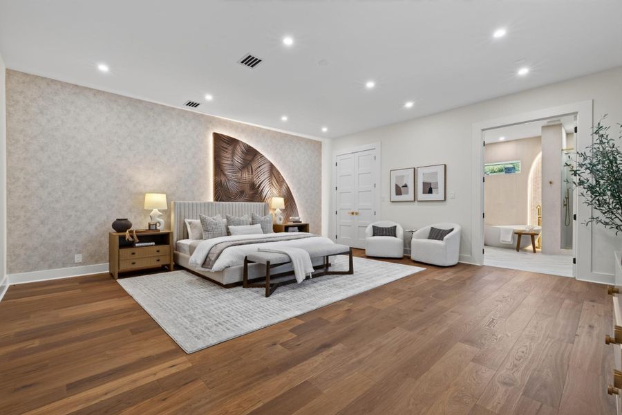 Spacious primary suite offers a serene retreat with hardwood floors and generous natural light.