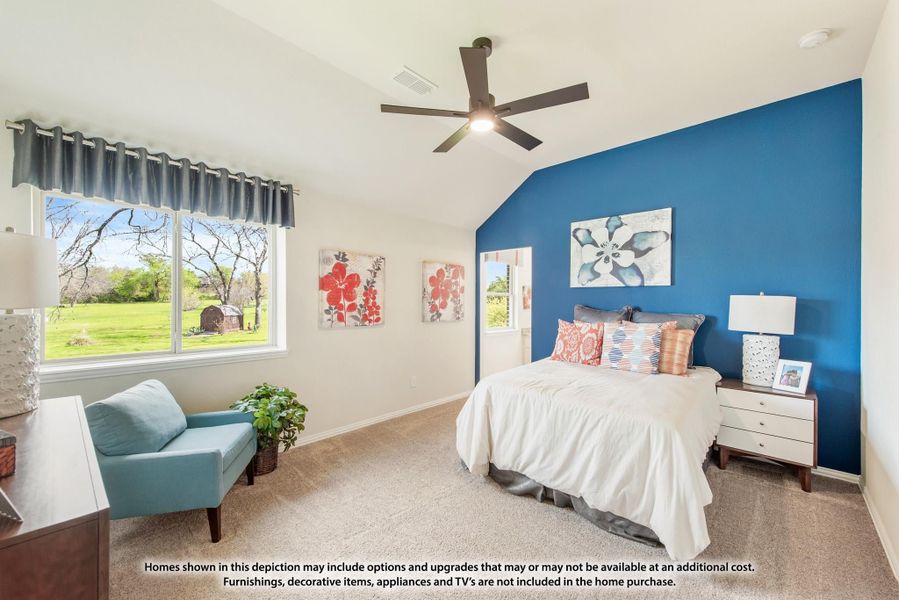 Bedroom with blue accent wall, vaulted ceiling, ceiling fan, and carpet flooring