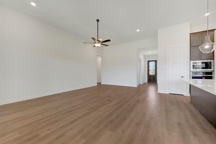 Open-concept living space with wood-finish flooring Open-concept living space with wood-finish flooring
