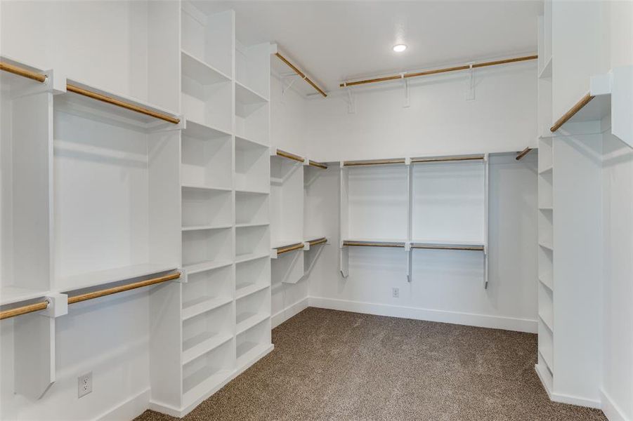 Spacious closet featuring dark carpet Spacious closet featuring dark carpet