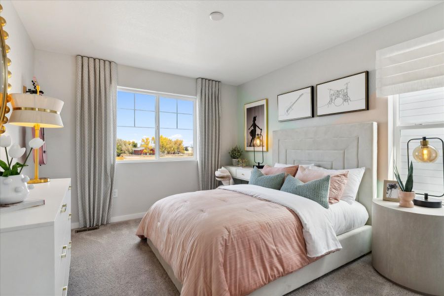 A bedroom with a bed and a window. A bedroom with a bed and a window.