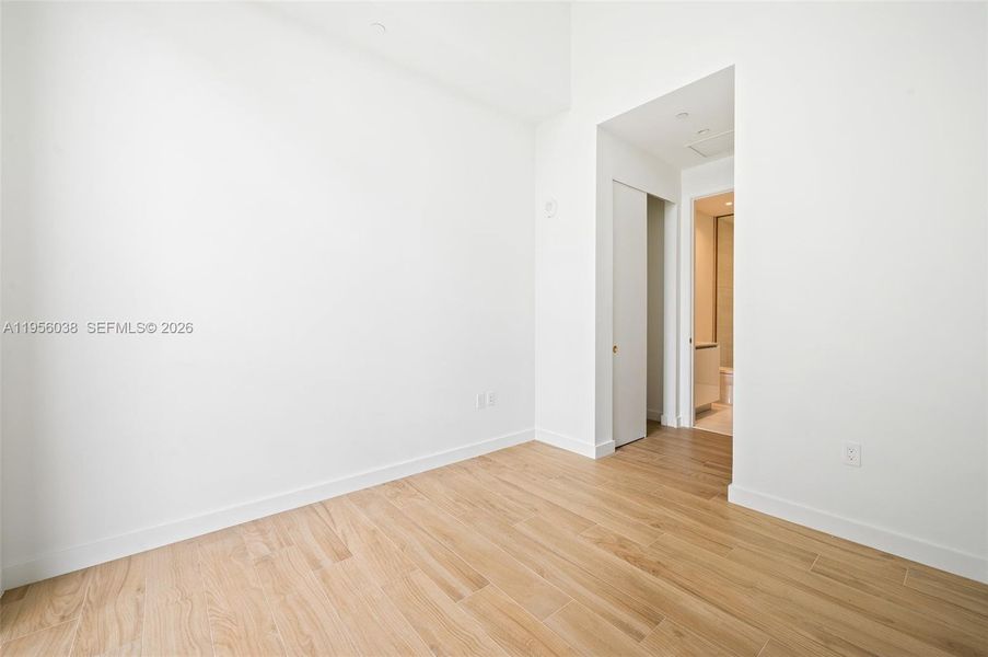 Versatile second bedroom ideal for guests, home office, or den, featuring oversized windows and contemporary finishes at Mr. C Coconut Grove. Ceilings