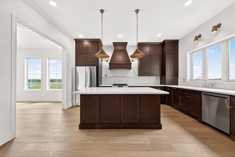 Stunning kitchen featuring a large island, perfected with decorative lighting fixtures