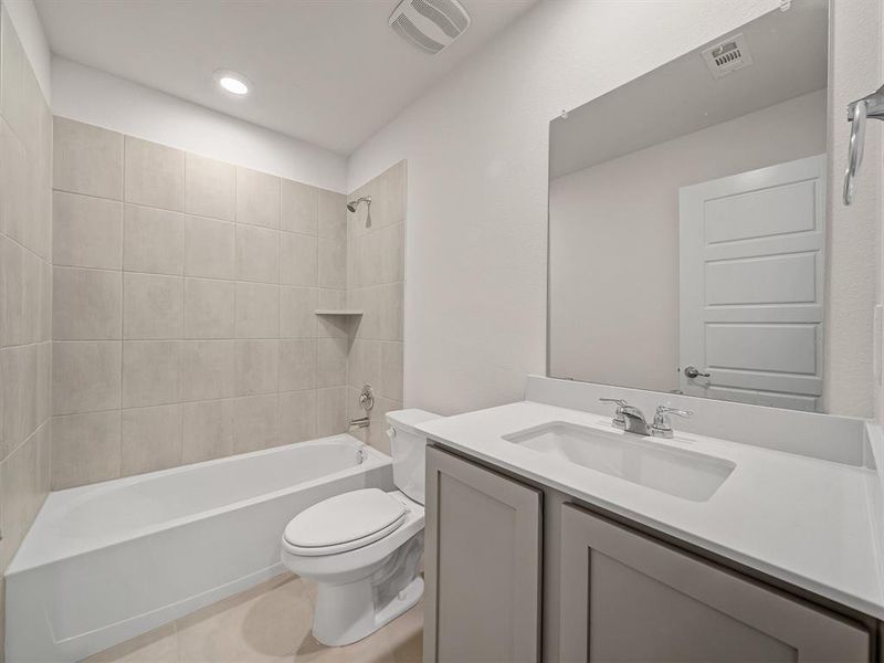 Full bath with visible vents, toilet, vanity, and bathing tub / shower combination