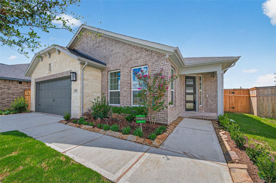 The side entryway, where a charming walkway framed by fresh landscaping leads you right up to the inviting front door.