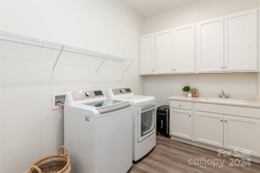 Laundry room with sink and cabinetry