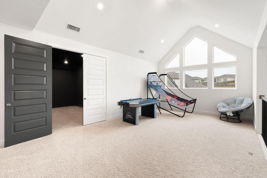 Well-lit bonus room with vaulted ceilings and large windows provides an ideal flex space.