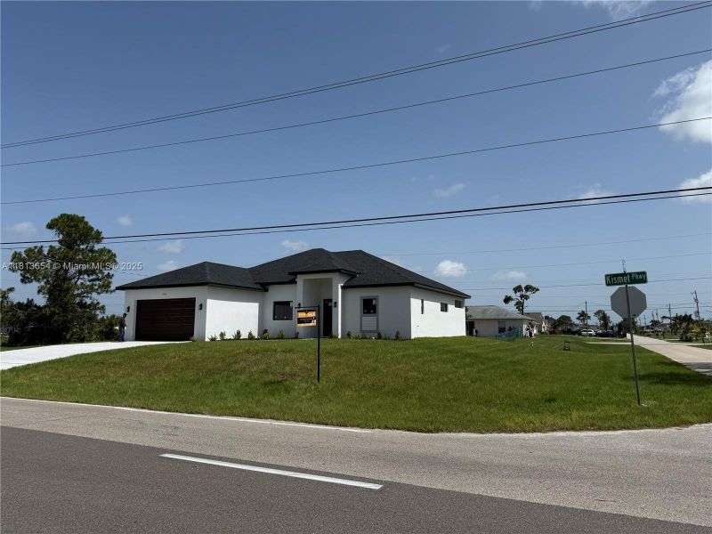 Front exterior of a new home in , Cape Coral, FL, highlighting curb appeal (Image 1). Front exterior of a new home in , Cape Coral, FL, highlighting curb appeal (Image 1).