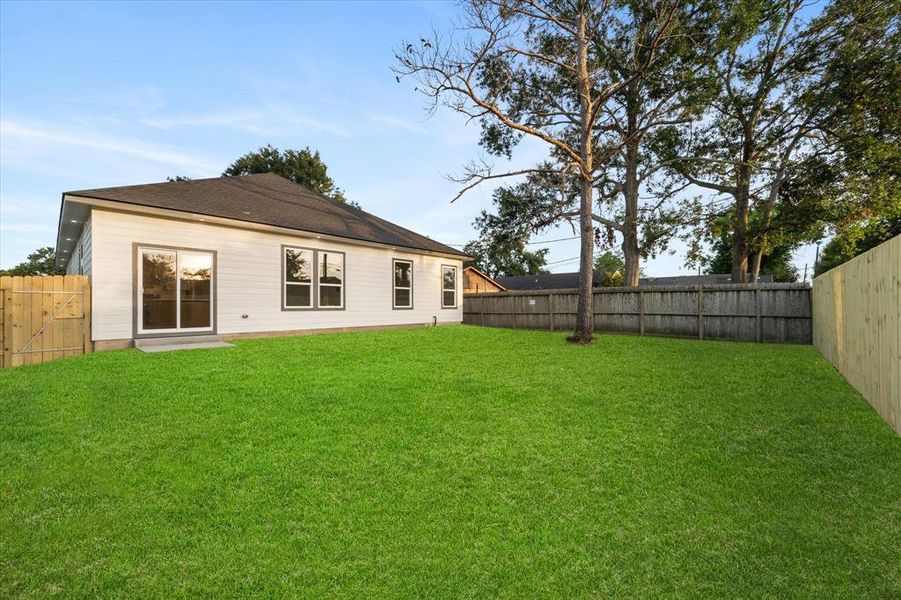 The spacious backyard is illuminated by plenty of soffit lights, making it the perfect spot for your furry friends or little ones to run around and enjoy the outdoors!