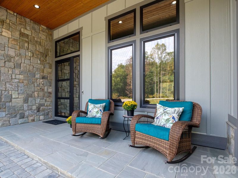 Welcoming covered entrance with striking front door