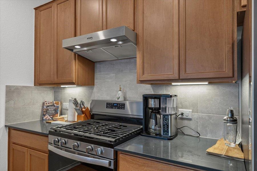 A sleek, modern kitchen boasts stainless steel appliances and abundant cabinetry, ideal for culinary creations.