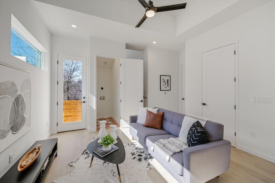 Living room featuring ceiling fan and light wood-type flooring