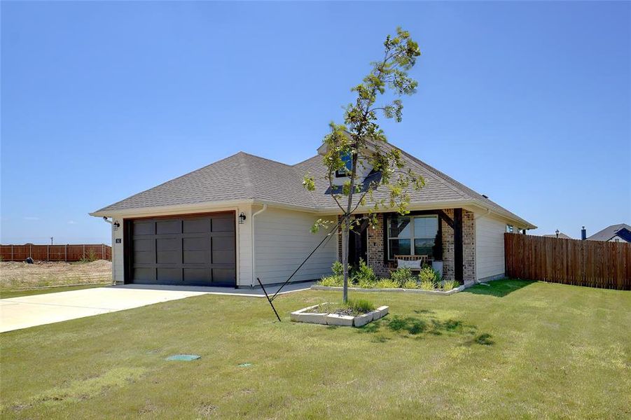 Ranch-style house with a front lawn and a garage