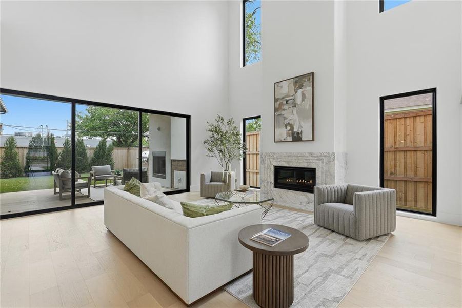 Double-height living area featuring light wood-finish flooring Double-height living area featuring light wood-finish flooring
